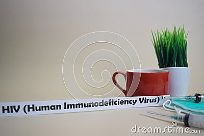 HIV Human Immunodeficiency Virus text, grass pot, coffee cup, syringe, and face green mask. Stock Photo