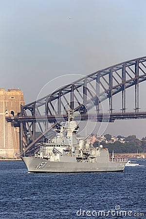 HMAS Perth FFH 157 Anzac-class frigate of the Royal Australian Navy sailing under the iconic Sydney Harbor Bridge Editorial Stock Photo