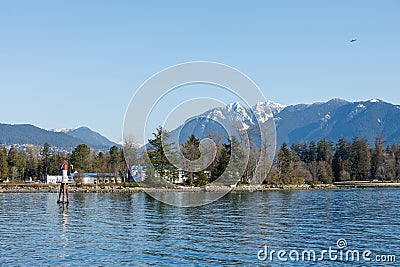 HMCS Discovery military base on a Deadman Island in Vancouver Stanley Park with mountains in the background Editorial Stock Photo