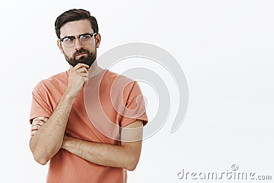 Hmm need think up plan. Portrait of determined and thoughtful creative perplexed guy smirking rubbing beard thoughtful Stock Photo