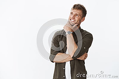 Hmm not bad at all. Satisfied good-looking european blond man with blue eyes and white perfect smile grinning pleased as Stock Photo