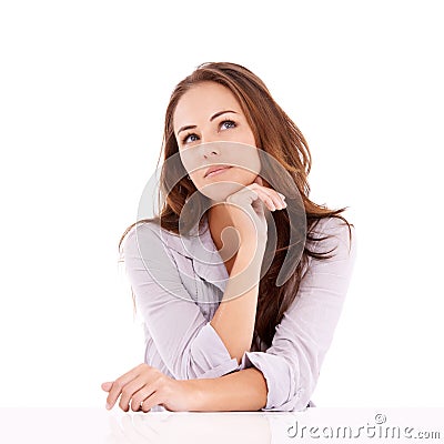 Hmmm, I wonder what I should do...Casually dressed woman sitting and looking thoughtful - isolated on white. Stock Photo