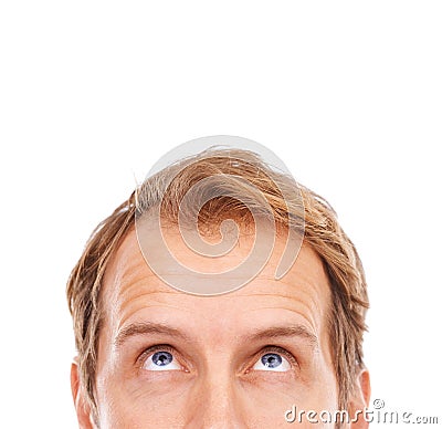 Hmmm... very interesting. Cropped shot of the upper half of a young mans face looking up at copyspace. Stock Photo