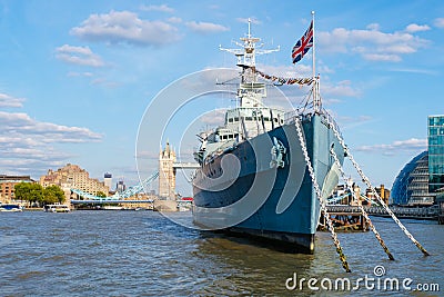 The HMS Belfast warship docked near Tower Bridge on the river Thames Editorial Stock Photo