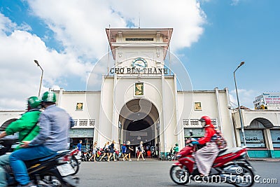 Ho Chi Minh City: the facade of Ben Thanh Market with a group of blonde girls and street traffic blurred in motion Editorial Stock Photo