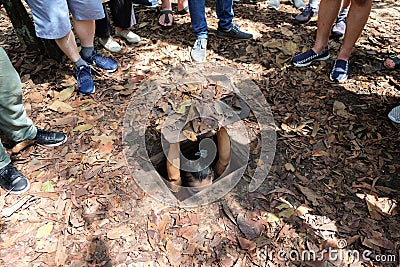 Ho Chi Minh City, Vietnam - April 30, 2018 : Tourist demonstrating how a Vietcong hide into Cu Chi Tunnels Editorial Stock Photo