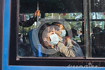 HO CHI MINH CITY,VIETNAM - DEC 10: People wearing mouth mask against air smog pollution PM 2.5 and Coronavirus on bus public in H Editorial Stock Photo