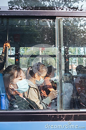HO CHI MINH CITY,VIETNAM - DEC 10: People wearing mouth mask against air smog pollution PM 2.5 and Coronavirus on bus Editorial Stock Photo