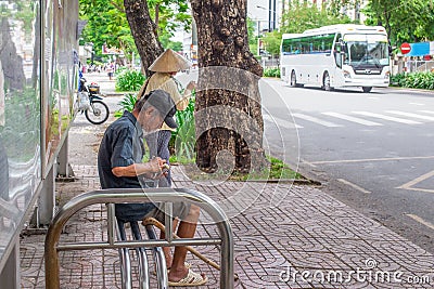 Ho Chi Minh City, Vietnam - September 1, 2018: an undefined man is getting everything ready before getting on the bus. Editorial Stock Photo