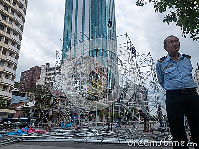 Ho Chi Minh, Vietnam - December 17,2019 : Asian male Security gaurd watching over workers Editorial Stock Photo