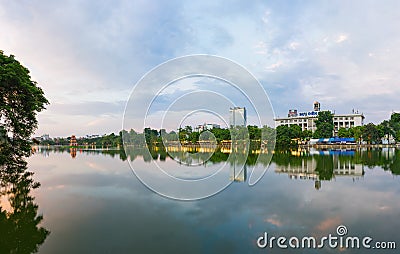 Hoan Kiem lake panorama view at sunset period with ancient Turtle Tower and Hanoi post office. Hoan Kiem lake or Sword lake or Ho Stock Photo