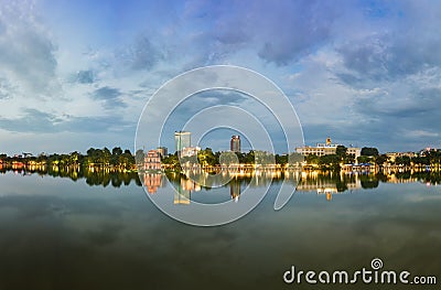 Hoan Kiem lake panorama view at sunset period with ancient Turtle Tower and Hanoi post office. Hoan Kiem lake or Sword lake or Ho Stock Photo