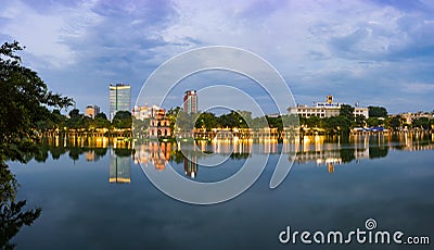 Hoan Kiem lake panorama view at sunset period with ancient Turtle Tower and Hanoi post office. Hoan Kiem lake or Sword lake or Ho Stock Photo