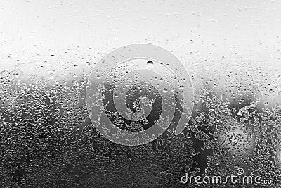 Hoarfrost on window. Black and white backdrop. Condensation drop on glass Stock Photo