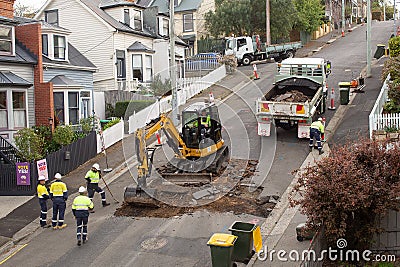 Machinery and workers repairing street surface Editorial Stock Photo