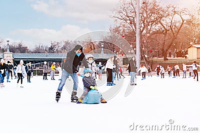 Hobbies and Leisure.Winter sports.Family winter sport.Holiday and seasonal concept.Activity,Adult,Child,Childhood Editorial Stock Photo