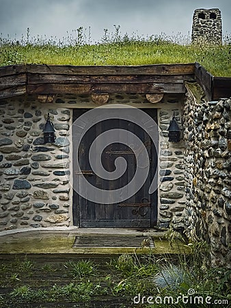 A hobbit house hidden underground part of the Clay Castle from the Valley of Fairies, a touristic complex in Transylvania, Romania Editorial Stock Photo