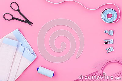 Hobby sewing with thread, scissors, fabric. Lifestyle. Pink background top view mock up Stock Photo