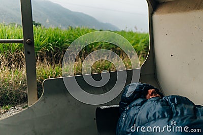 hobo a man sleeps and rides illegally on a freight train Stock Photo