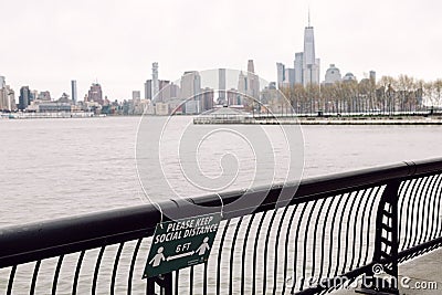 Hoboken, United States - April 19th, 2020 - Sign on the Hoboken Waterfront outlines the new social distancing guidelines Editorial Stock Photo