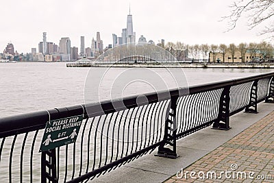 Hoboken, United States - April 19th, 2020 - Sign on the Hoboken Waterfront outlines the new social distancing guidelines Editorial Stock Photo