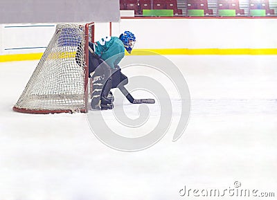 Hockey goalkeeper in helmet and gate Stock Photo