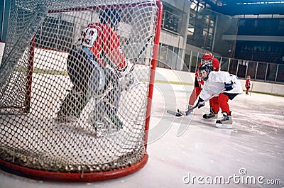 Hockey goals, shoots the puck and attacks goalkeeper Stock Photo