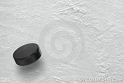 Hockey puck on ice Stock Photo