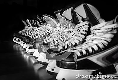 Hockey skates lined up in locker room Stock Photo