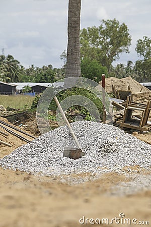 The hoe on pile small stones for construction Stock Photo