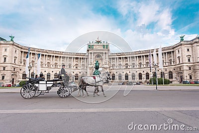 Hofburg Palace and Heldenplatz with a passing carriage with a pair of horses, Vienna, Austria Editorial Stock Photo