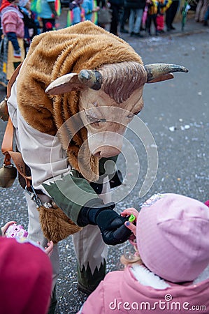 Parade participants in cow costumes and masks Editorial Stock Photo