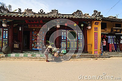 Hoi An, Vietnam - 13 April 2013: A garbage collector and her bicycle, Hoi An Ancient Town Editorial Stock Photo