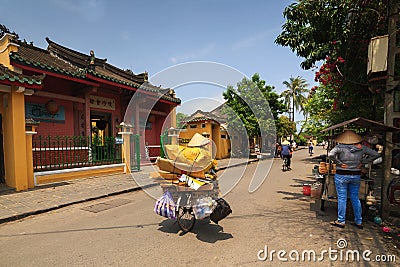 Hoi An, Vietnam - 13 April 2013: A garbage collector and her bicycle, Hoi An Ancient Town Editorial Stock Photo