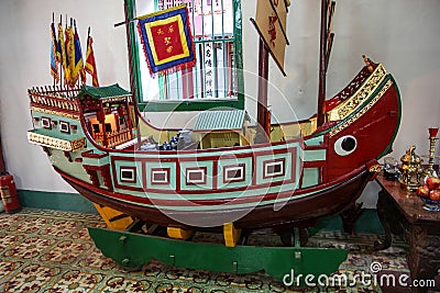 An old vintage antique miniature ship on display at a historic heritage house in the town of Hoi An Editorial Stock Photo