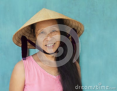 Hoi An, VIETNAM, July 2017 : closeup face portrait of vietnamese woman wearing conical hat Editorial Stock Photo