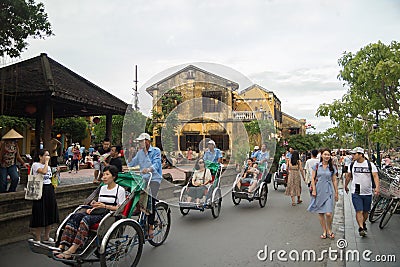 Hoi An, Vietnam - June 2017: cyclo rickshaw driving on street in Hoi An Vietnam Editorial Stock Photo