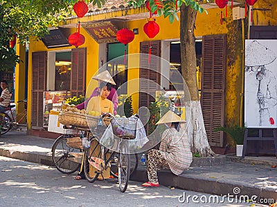 HOIAN, VIETNAM, SEPTEMBER, 04 2017: Unidentified people at street view with old houses, and colorful lanters made of Editorial Stock Photo