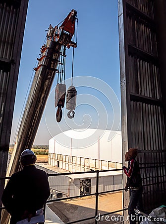 Hoist of crane at the window of industrial plant Editorial Stock Photo