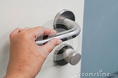 Hold doorknob to open the office door Stock Photo