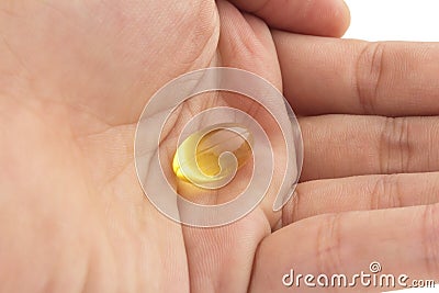 hold fish oil eatingCapsules fish oil isolate on white backgrou Stock Photo