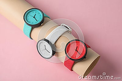 Holder with collection of stylish wrist watches on color background. Stock Photo