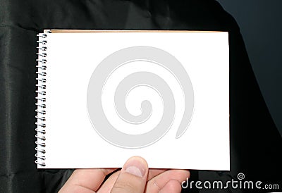 Holding blank spiral notebook on abstract background Stock Photo