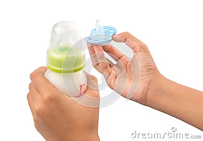 Holding Blue Pacifier and Infant Formula I Stock Photo