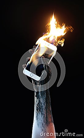 Holding a burning cell phone Stock Photo