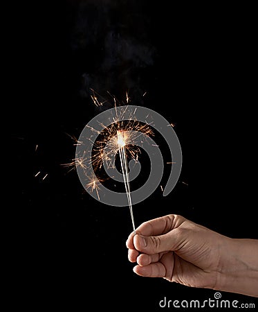 Holding a burning sparkler Stock Photo