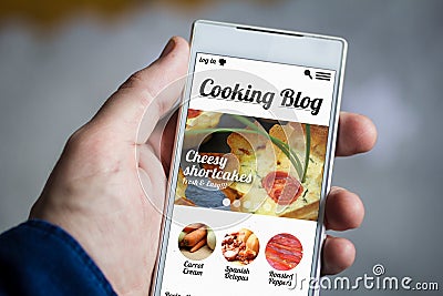 holding cooking blog smartphone Stock Photo