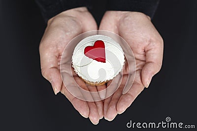 Holding a Cupcake with Love Hearts Stock Photo