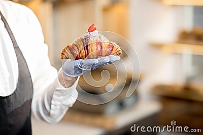 Holding delicious croissant Stock Photo