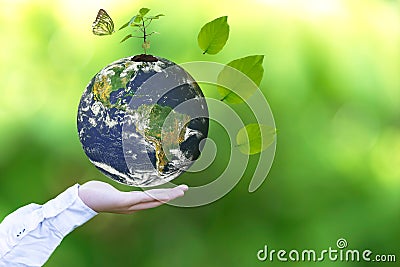 Holding a glowing earth globe in his hands with butterfly. Stock Photo
